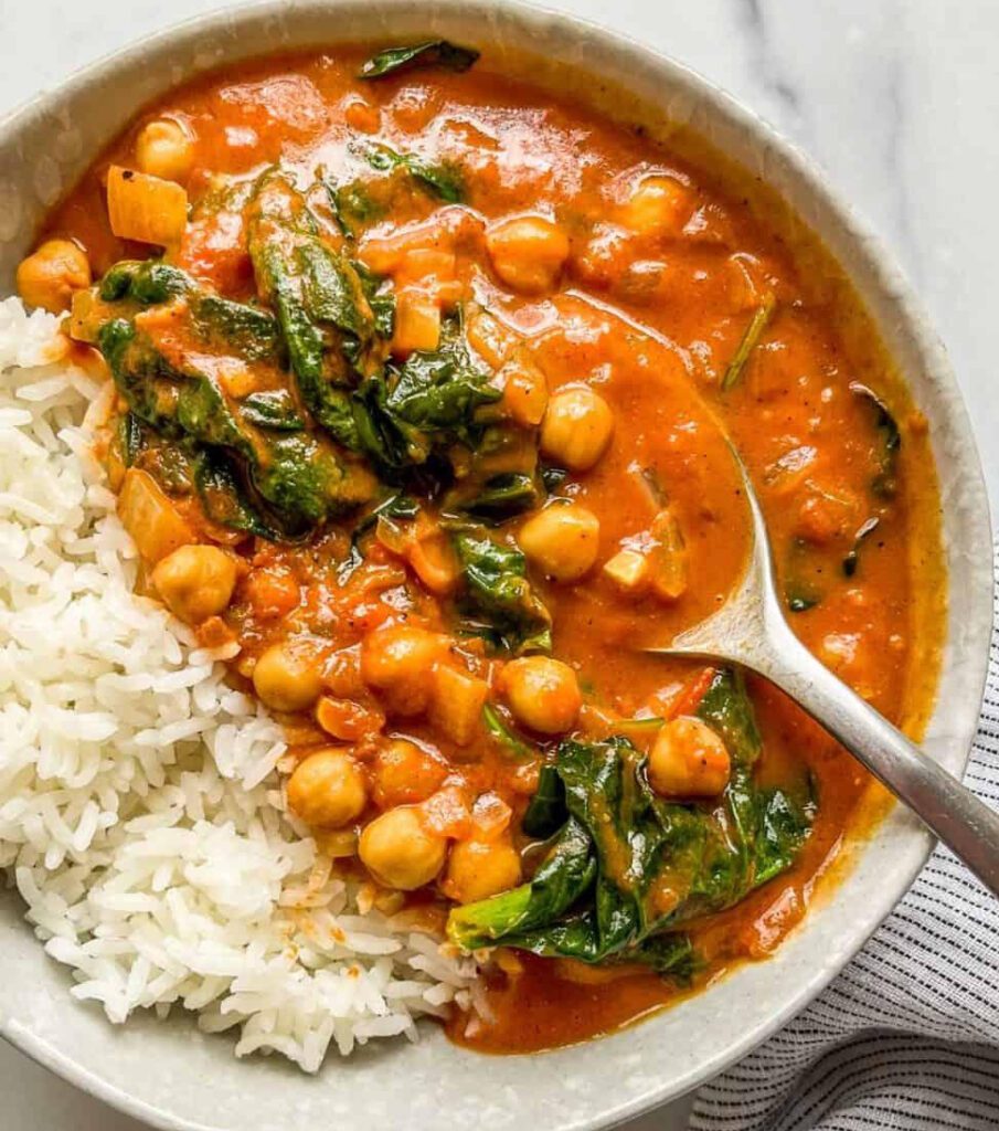 cooking chickpea spinach curry with steamed rice