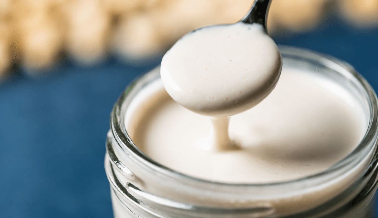 Dairy free heavy cream substitute made with cashews and plant milk in a glass jar
