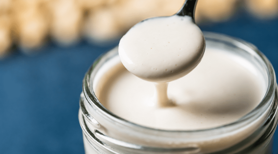 Dairy free heavy cream substitute made with cashews and plant milk in a glass jar