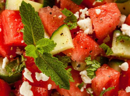 Fresh watermelon feta salad with mint leaves, vegan feta cheese, and lime dressing served in a bowl.