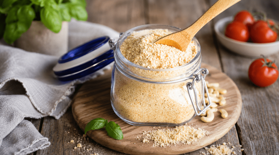 Homemade vegan Parmesan cheese substitute in a bowl made with cashews and nutritional yeast.