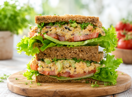 Vegan tuna sandwich made with mashed chickpeas, vegan mayonnaise, celery, and lettuce on whole grain bread.