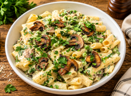 Creamy vegan one pot pasta served in a bowl and garnished with fresh herbs and vegan parmesan.