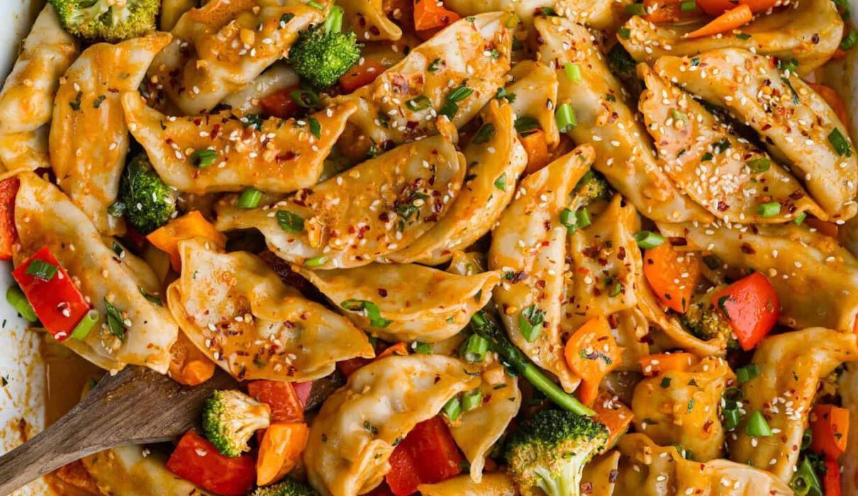 Vegan dumpling bake with fluffy golden dumplings baked over a savory vegetable filling in a casserole dish.