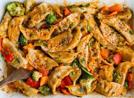 Vegan dumpling bake with fluffy golden dumplings baked over a savory vegetable filling in a casserole dish.