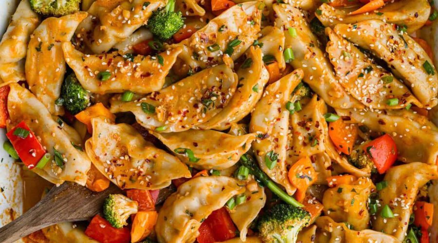 Vegan dumpling bake with fluffy golden dumplings baked over a savory vegetable filling in a casserole dish.