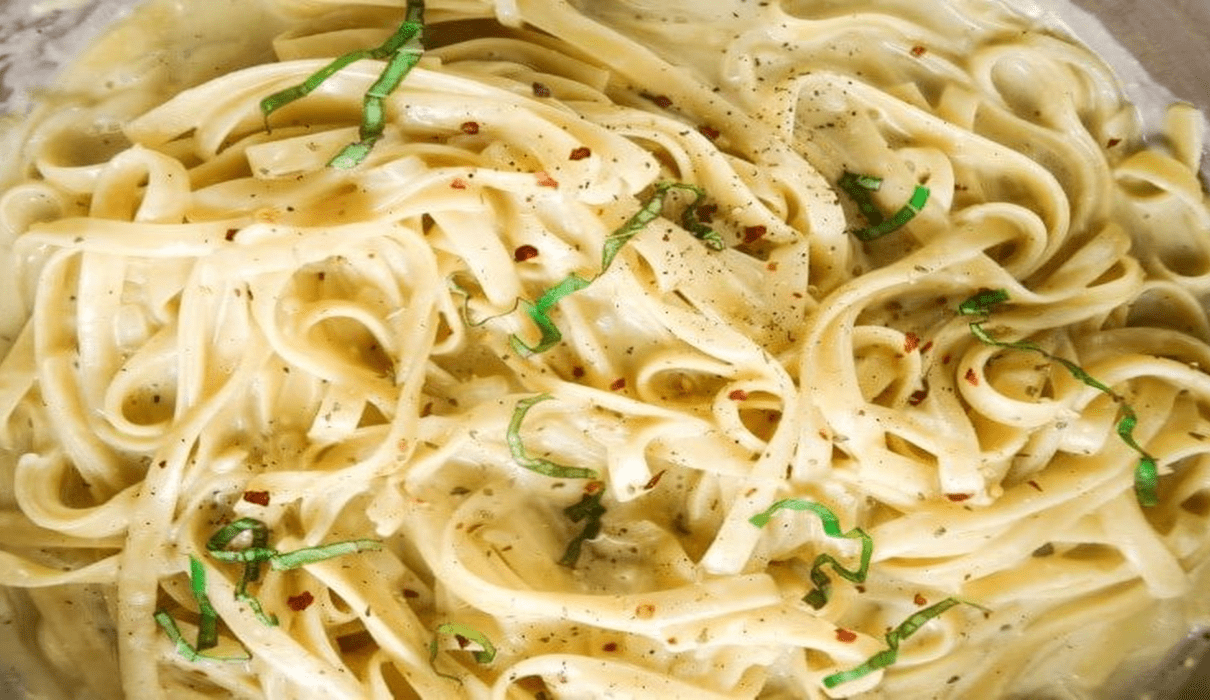 Assortment of vegan pasta sauces served with different pasta dishes on a table.